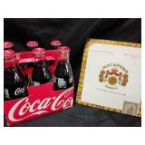 Coca-Cola b9ttles, cigarette box, royal seat