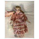 Porcelain doll with umbrella.