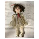 Mini porcelain doll.