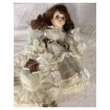 Porcelain doll with hat.