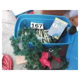 Outdoor spotlight, Christmas candles, and garland