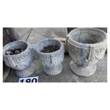 Three concrete planters one has some cracks