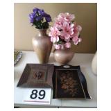 Vases with artificial flowers and decor trays
