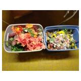 Totes of faux flowers and plants