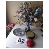 Artificial flowers in vase on stand, matching