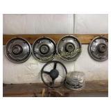 11 Hubcaps and 1 Datsun Steering Wheel