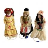 Three Porcelain Dolls in Ethnic Attire