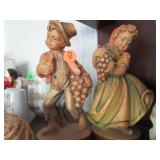 Pair Heinzeller carved wood boy and girl w/grapes