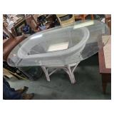 Wicker table with glass top. 60 X 36 X 30 inches