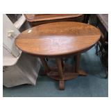 Oval oak table with 4 column legs running into
