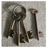 Ring of 3 brass keys and one loose key.