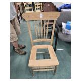 Pressed back oak side chair in middle of