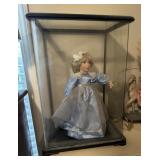 Doll in glass case
