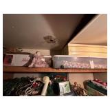 Group of dolls and Christmas on top shelf