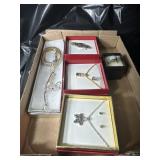 Flat of costume jewelry in boxes