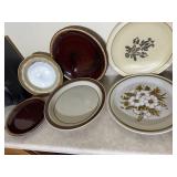 Group of plates including brown drip