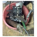 grease gun, motor, and misc in red bucket