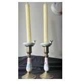 two floral brass candle sticks and candles