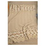 Brown and cream colored coverlet