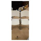 Pair of white plastic folding chairs