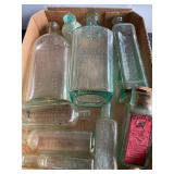 9 green glass bottles, tallest 9"