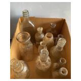 12 clear glass bottles, tallest 10"