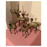4 Brass like deer candlesticks, tallest is 10"