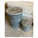 2 metal trash cans w/lids, show some wear, large