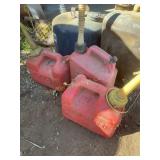 5 gas/oil containers with contents