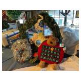 Christmas wreaths, some with lights, calendar,