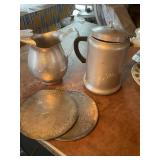 2 holiday metal hot pads 8" dia, metal pitcher &