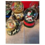 4 snow globes, some musical, 1 has no liquid