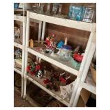 Shelving unit with contents, glass, votive, and