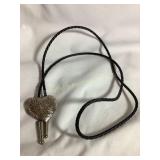 Engraved silver heart bolo tie with black l
