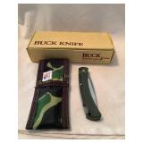 Buck folding knife with camo sheath