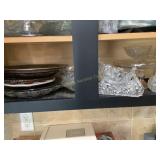 Contents of cabinet shelf- glassware, trays, c
