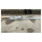 3 WHITE METAL SHELVES, 12 FEET LONG AND BRACKETS