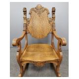 Antique carved oak lion rocking chair w/ arms
