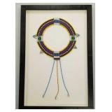 Tribal beaded choker in a shadowbox frame-
