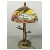 Metal figural lamp with hand painted beach scene