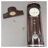 2 clocks incl Howard Miller curved glass wall