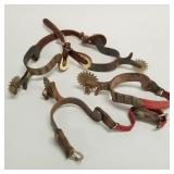 2 pair spurs with silver tone metal decoration,