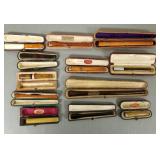 12 vintage cigarette etc holders in fitted cases -