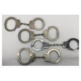 (4) SETS OF HANDCUFFS W/ NO KEYS