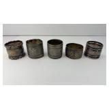 (4) STERLING NAPKIN RINGS , (1) BRASS RING