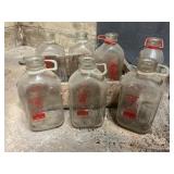 Seven Glass Milk Bottles in Pepsi Crate
