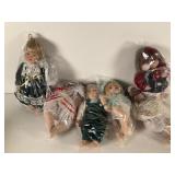 Six Porcelain Dolls in Plastic Bags