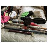 Grouping of umbrellas, some never used and hats.