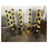 A Group of Striped Safety Stanchions and Chain