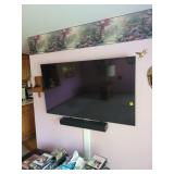 Flat-Screen TV With Soundbar on Mount